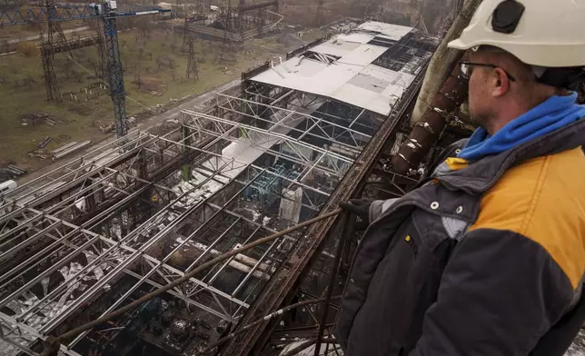 A worker looks on a production hall after a recent Russian missile attack at DTEK's power plant in Ukraine, Nov. 28, 2024. (AP Photo/Evgeniy Maloletka)