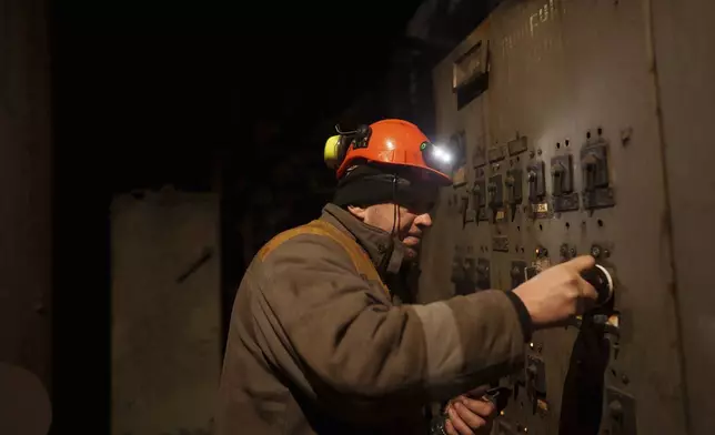 A worker repairs equipment at DTEK's power plant after a recent Russian missile attack in Ukraine, Nov. 28, 2024. (AP Photo/Evgeniy Maloletka)