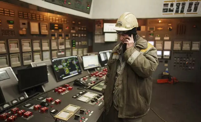 A worker speaks by mobile phone inside operating room at DTEK's power plant after a recent Russian missile attack in Ukraine, Nov. 28, 2024. (AP Photo/Evgeniy Maloletka)