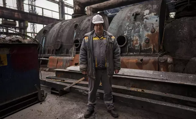 Oleksandr, 52, head of the Production Management Department stands in front of destroyed turbine at DTEK's power plant after a recent Russian missile attack in Ukraine, Nov. 28, 2024. (AP Photo/Evgeniy Maloletka)