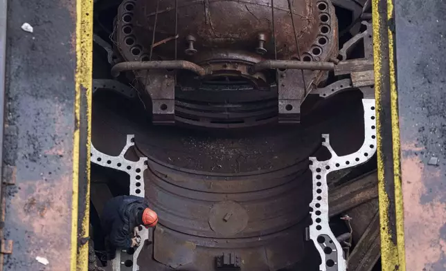 Worker repair equipment at DTEK's power plant after a recent Russian missile attack in Ukraine, Nov. 28, 2024. (AP Photo/Evgeniy Maloletka)