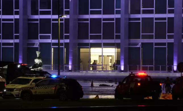 A body lies outside the Supreme Court in Brasília, Brazil, following an explosion, Wednesday, Nov. 13, 2024. (AP Photo/Eraldo Peres)