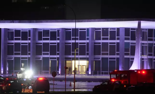 Police vehicles are parked outside the Supreme Court in Brasília, Brazil, following an explosion, Wednesday, Nov. 13, 2024. (AP Photo/Eraldo Peres)