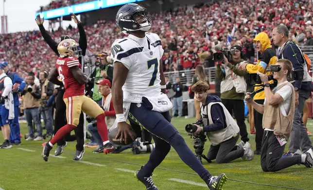 Seattle Seahawks quarterback Geno Smith (7) reacts after scoring against the San Francisco 49ers during the second half of an NFL football game in Santa Clara, Calif., Sunday, Nov. 17, 2024. (AP Photo/Godofredo A. Vásquez)