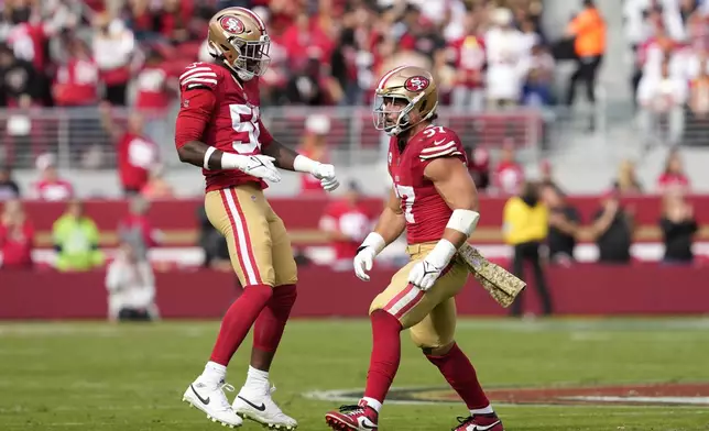 San Francisco 49ers defensive end Leonard Floyd, left, and defensive end Nick Bosa (97) celebrate after Bosa sacked Seattle Seahawks quarterback Geno Smith during the first half of an NFL football game in Santa Clara, Calif., Sunday, Nov. 17, 2024. (AP Photo/Godofredo A. Vásquez)