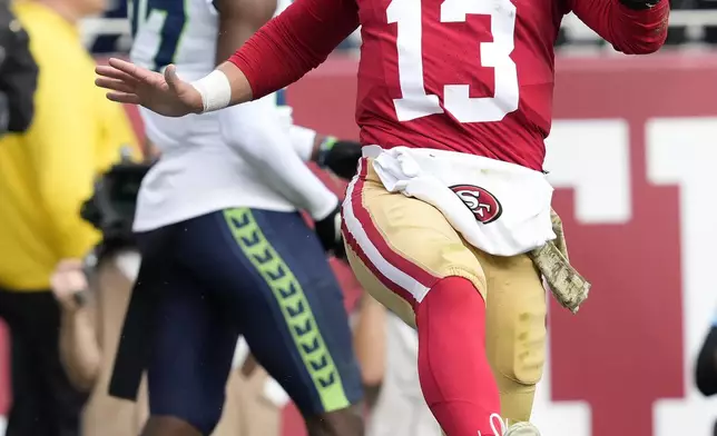 San Francisco 49ers quarterback Brock Purdy (13) celebrates after scoring against the Seattle Seahawks during the first half of an NFL football game in Santa Clara, Calif., Sunday, Nov. 17, 2024. (AP Photo/Godofredo A. Vásquez)