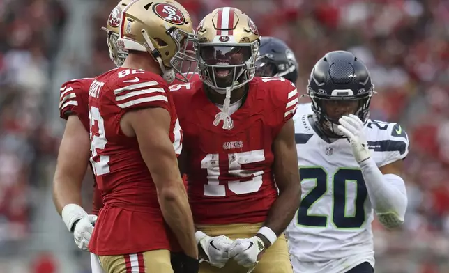 San Francisco 49ers wide receiver Jauan Jennings (15) celebrates with teammates in front of Seattle Seahawks safety Julian Love (20) during the second half of an NFL football game in Santa Clara, Calif., Sunday, Nov. 17, 2024. (AP Photo/Jed Jacobsohn)