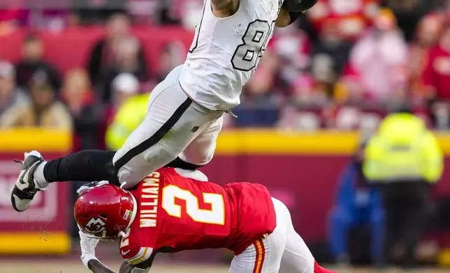 Las Vegas Raiders tight end Brock Bowers (89) tries to leap over Kansas City Chiefs cornerback Joshua Williams (2) during the first half of an NFL football game in Kansas City, Mo., Friday, Nov. 29, 2024. (AP Photo/Ed Zurga)