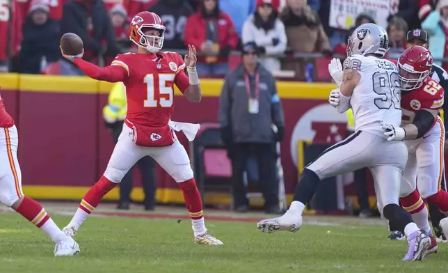 Kansas City Chiefs quarterback Patrick Mahomes (15) throws against the Las Vegas Raiders during the first half of an NFL football game in Kansas City, Mo., Friday, Nov. 29, 2024. (AP Photo/Charlie Riedel)