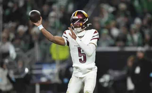 Washington Commanders quarterback Jayden Daniels throws during the first half of an NFL football game against the Philadelphia Eagles Thursday, Nov. 14, 2024, in Philadelphia. (AP Photo/Matt Slocum)