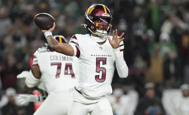 Washington Commanders quarterback Jayden Daniels throws during the first half of an NFL football game against the Philadelphia Eagles Thursday, Nov. 14, 2024, in Philadelphia. (AP Photo/Matt Slocum)