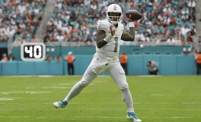 Miami Dolphins quarterback Tua Tagovailoa (1) throws a touchdown pass to wide receiver Tyreek Hill (10) during the second half of an NFL football game against the Las Vegas Raiders, Sunday, Nov. 17, 2024, in Miami Gardens, Fla. (AP Photo/Lynne Sladky)