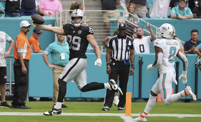 Las Vegas Raiders tight end Brock Bowers (89) scores a touchdown during the second half of an NFL football game against the Miami Dolphins, Sunday, Nov. 17, 2024, in Miami Gardens, Fla. (AP Photo/Rebecca Blackwell)