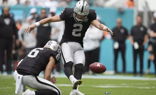 Las Vegas Raiders place kicker Daniel Carlson (2) kicks a field goal during the first half of an NFL football game against the Miami Dolphins, Sunday, Nov. 17, 2024, in Miami Gardens, Fla. (AP Photo/Rebecca Blackwell)