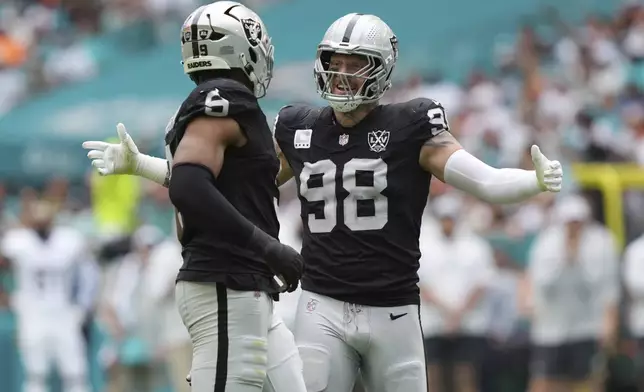 Las Vegas Raiders defensive end Maxx Crosby (98) celebrates a sack during the first half of an NFL football game against the Miami Dolphins, Sunday, Nov. 17, 2024, in Miami Gardens, Fla. (AP Photo/Lynne Sladky)