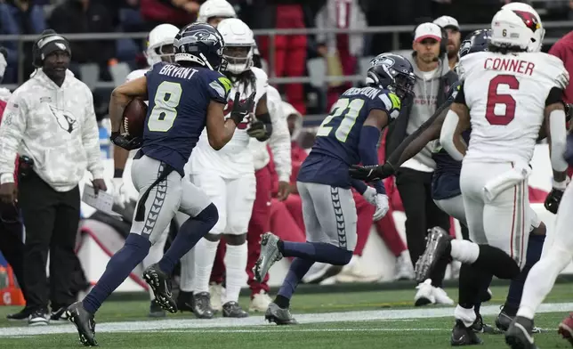 Seattle Seahawks cornerback Coby Bryant (8) returns an interception for a touchdown during the second half of an NFL football game against the Arizona Cardinals, Sunday, Nov. 24, 2024, in Seattle. (AP Photo/Stephen Brashear)