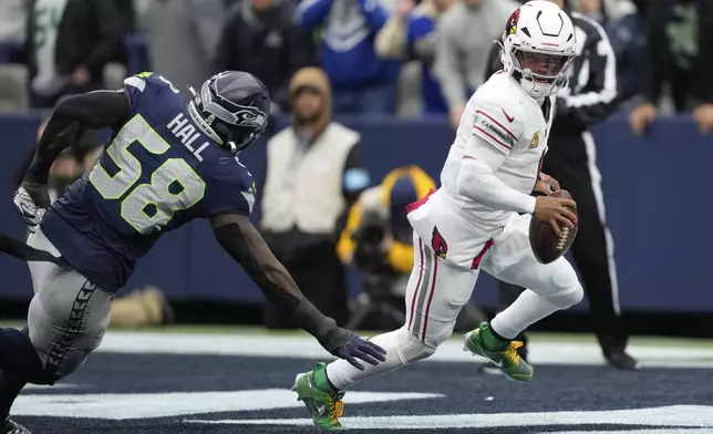 Seattle Seahawks linebacker Derick Hall (58) defends as Arizona Cardinals quarterback Kyler Murray (1) looks to get around him during the first half of an NFL football game Sunday, Nov. 24, 2024, in Seattle. (AP Photo/Stephen Brashear)