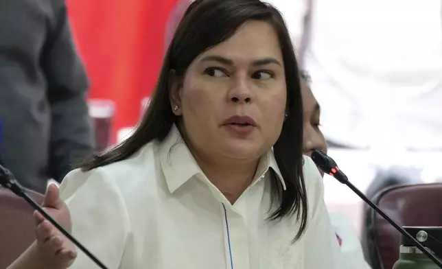 Philippine Vice President Sara Duterte gestures as she attends a hearing at the House of Representative in Quezon City, Philippines on Monday Nov. 25, 2024. (AP Photo/Aaron Favila)