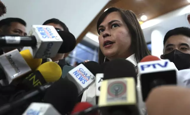 Philippine Vice President Sara Duterte talks to reporters while a hearing she is attending is suspended at the House of Representative in Quezon City, Philippines Monday, Nov. 25, 2024. (AP Photo/Aaron Favila)