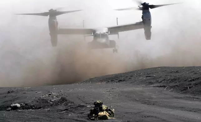 FILE - An MV-22 Osprey takes off as Japan Ground Self-Defense Force guards the landing zone during a joint military drill with U.S. Marines in Gotemba, southwest of Tokyo, March 15, 2022. (AP Photo/Eugene Hoshiko, File)