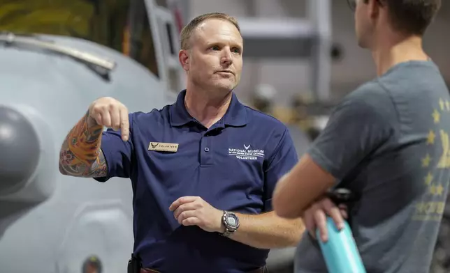 Brian Luce, left, speaks with museum visitor Ben Perkins inside of the Wright Patterson AFB Air Force Museum, Friday, Aug. 9, 2024, in Dayton, Ohio. (AP Photo/Jeff Dean)