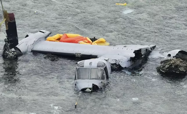 FILE - Wreckage of a U.S. military MV-22 Osprey is seen in shallow waters off Nago, Okinawa, southern Japan, Dec. 14, 2016, after it crash landed. (Yu Nakajima/Kyodo News via AP, File)