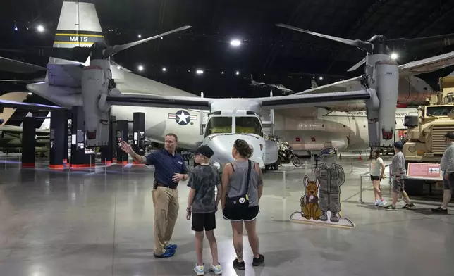 Former Air Force Osprey pilot Brian Luce, left, speaks with museum visitors inside of the Wright Patterson AFB Air Force Museum, Aug. 9, 2024, in Dayton, Ohio. (AP Photo/Jeff Dean)