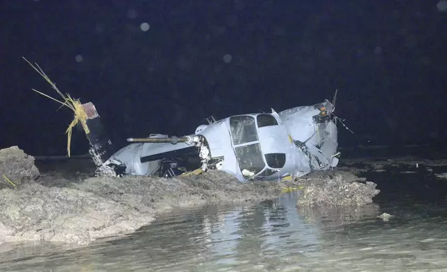 FILE - Wreckage of a MV-22 Osprey is seen in shallow waters off Nago, Okinawa, southern Japan, Dec. 14, 2016, after it crash landed. All five crew members were safely rescued. (Ryukyu Shimpo/Kyodo News via AP)