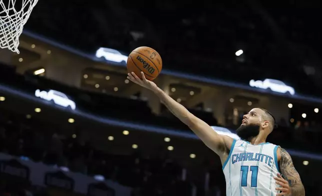 Charlotte Hornets forward Cody Martin drives to the basket during the first half of an NBA basketball game against the Miami Heat in Charlotte, N.C., Wednesday, Nov. 27, 2024. (AP Photo/Nell Redmond)