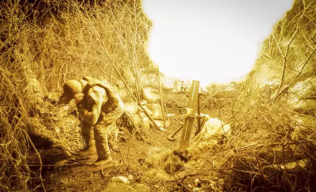 In this photo provided by Ukraine's 24th Mechanised Brigade press service, servicemen of the 24th Mechanised Brigade fire 120mm mortar towards Russian positions near Chasiv Yar town, in Donetsk region, Ukraine, Tuesday, Nov. 19, 2024. (Oleg Petrasiuk/Ukrainian 24th Mechanised Brigade via AP)