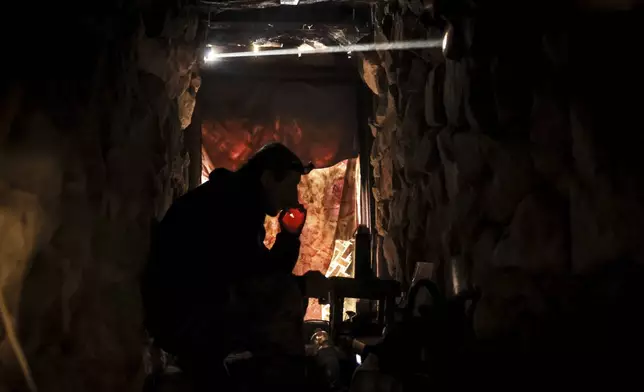 In this photo provided by Ukraine's 24th Mechanised Brigade press service, a serviceman of the 24th Mechanised Brigade rests in a shelter on the front line near Chasiv Yar town, in Donetsk region, Ukraine, Tuesday, Nov. 19, 2024. (Oleg Petrasiuk/Ukrainian 24th Mechanised Brigade via AP)