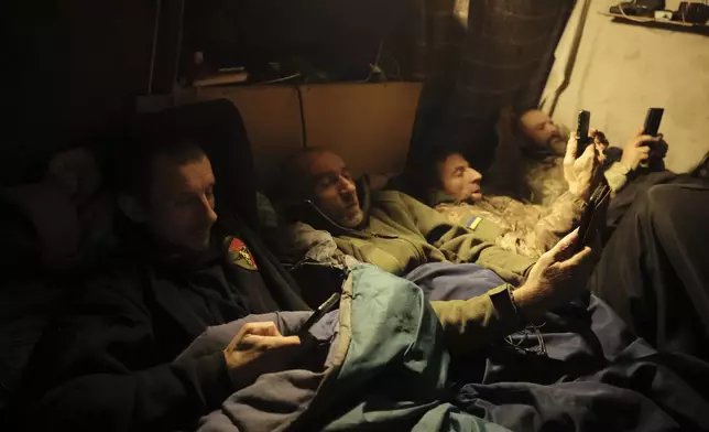 In this photo provided by Ukraine's 24th Mechanised Brigade press service, servicemen of the 24th Mechanised Brigade rest in a shelter on the front line near Chasiv Yar town, in Donetsk region, Ukraine, Tuesday, Nov. 19, 2024. (Oleg Petrasiuk/Ukrainian 24th Mechanised Brigade via AP)