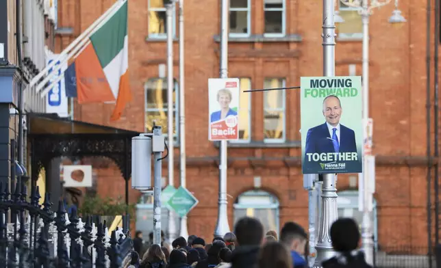 Irish election posters hang from lampposts in Dublin City centre, Tuesday, Nov. 26, 2024, ahead of Ireland's election on Friday. (AP Photo/Peter Morrison)