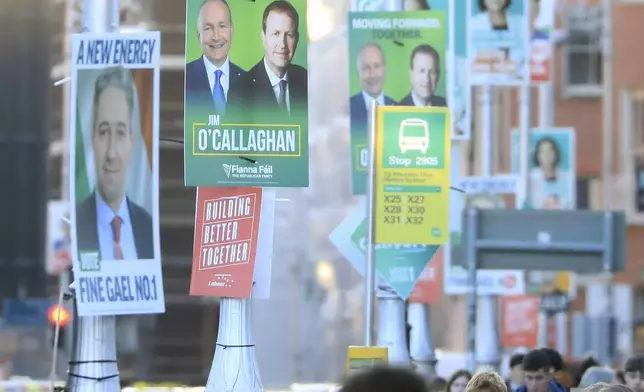 Irish election posters hang from lamp posts in Dublin City centre, Tuesday, Nov. 26, 2024, ahead of Ireland's election on Friday. (AP Photo/Peter Morrison)