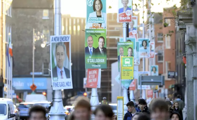 Irish election posters hang from lampposts in Dublin City centre, Tuesday, Nov. 26, 2024, ahead of Ireland's election on Friday. (AP Photo/Peter Morrison)