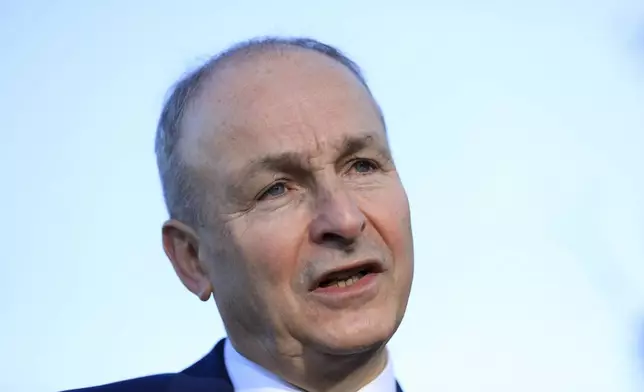 Micheal Martin, Tanaiste of Ireland and leader of Fianna Fail speaks to the media during a visit to St Seton's Secondary School in Ballyfermot, Dublin, Ireland, Tuesday, Nov. 26, 2024. (AP Photo/Peter Morrison)