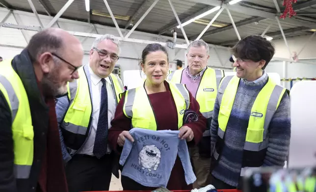 Sinn Fein leader Mary Lou McDonald, center, visits Liberty Recycling in Dublin, Ireland, Tuesday, Nov. 26, 2024, ahead of Ireland's election on Friday. (AP Photo/Peter Morrison)