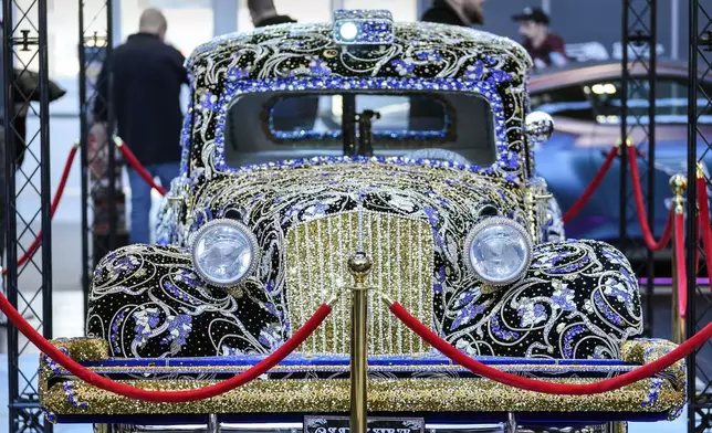 A vintage Citroen car is decorated with gemstones at the Essen Motor Show in Essen, Germany, Friday, Nov. 29, 2024.(AP Photo/Martin Meissner)