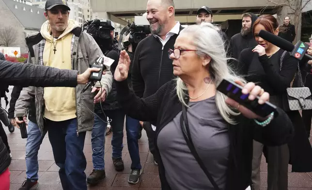 Pat King, rear center, a prominent figure in Canada’s trucker protests against COVID-19 restrictions in 2022, is joined by supporters as he leaves court in Ottawa, Ontario, Friday, Nov. 22, 2024. (Sean Kilpatrick/The Canadian Press via AP)