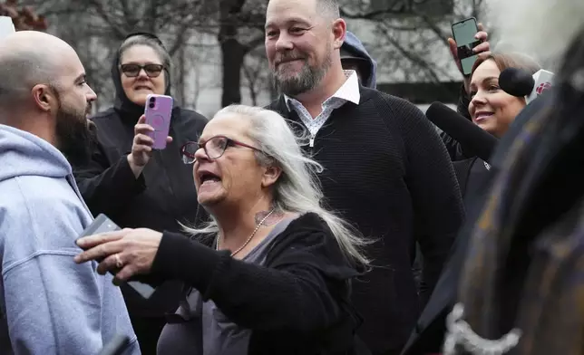 Pat King, top center, a prominent figure in Canada’s trucker protests against COVID-19 restrictions in 2022, is surrounded by supporters as he leaves court in Ottawa, Ontario, Friday, Nov. 22, 2024. (Sean Kilpatrick/The Canadian Press via AP)