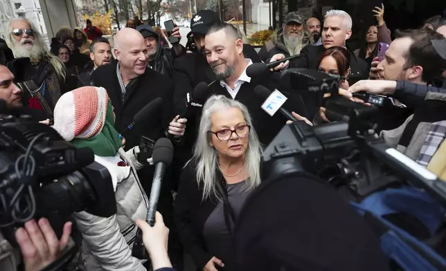 Pat King, top center, a prominent figure in Canada’s trucker protests against COVID-19 restrictions in 2022, is surrounded by supporters and media as he leaves court in Ottawa, Ontario, Friday, Nov. 22, 2024. (Sean Kilpatrick/The Canadian Press via AP)