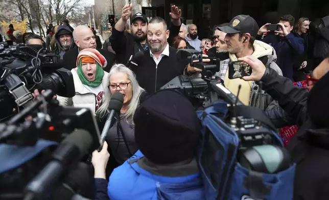 Pat King, a prominent figure in Canada’s trucker protests against COVID-19 restrictions in 2022, is surrounded by supporters as he leaves court in Ottawa, Ontario, Friday, Nov. 22, 2024. (Sean Kilpatrick/The Canadian Press via AP)