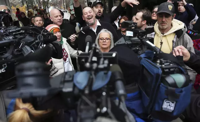 Pat King, top center, a prominent figure in Canada’s trucker protests against COVID-19 restrictions in 2022, is surrounded by supporters and media as he leaves court in Ottawa, Ontario, Friday, Nov. 22, 2024. (Sean Kilpatrick/The Canadian Press via AP)