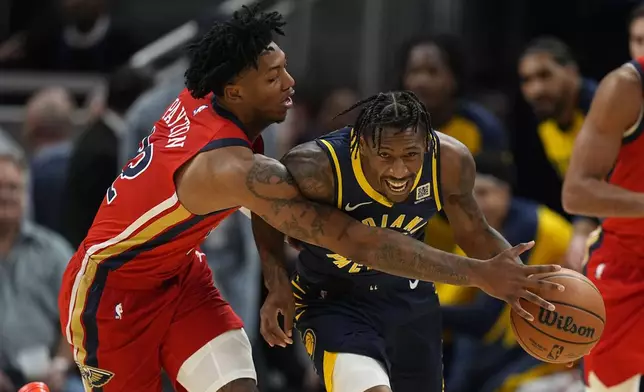 Indiana Pacers' Quenton Jackson (29) is fouled by New Orleans Pelicans' Elfrid Payton (22) during the first half of an NBA basketball game, Monday, Nov. 25, 2024, in Indianapolis. (AP Photo/Darron Cummings)