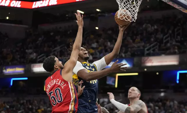 Indiana Pacers' Myles Turner (33) puts up a shot against New Orleans Pelicans' Jeremiah Robinson-Earl (50) during the first half of an NBA basketball game, Monday, Nov. 25, 2024, in Indianapolis. (AP Photo/Darron Cummings)