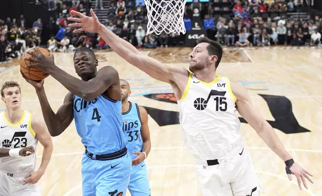 Los Angeles Clippers center Mo Bamba (4) grabs a rebound away from Utah Jazz forward Drew Eubanks during the first half of an NBA basketball game, Sunday, Nov. 17, 2024, in Inglewood, Calif. (AP Photo/Mark J. Terrill)