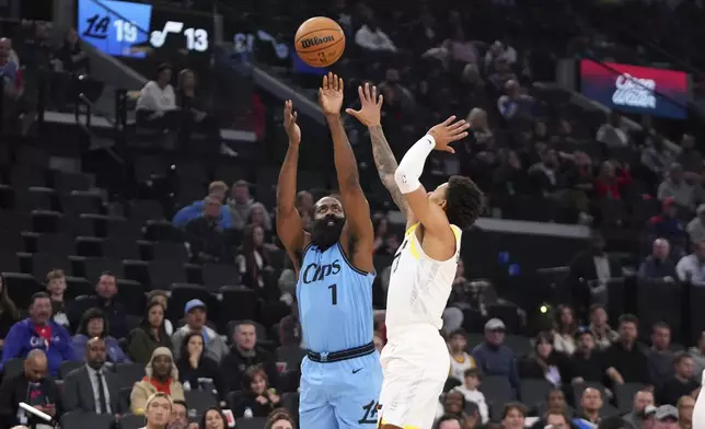 Los Angeles Clippers guard James Harden, left, shoots as Utah Jazz guard Keyonte George defends during the first half of an NBA basketball game, Sunday, Nov. 17, 2024, in Inglewood, Calif. (AP Photo/Mark J. Terrill)