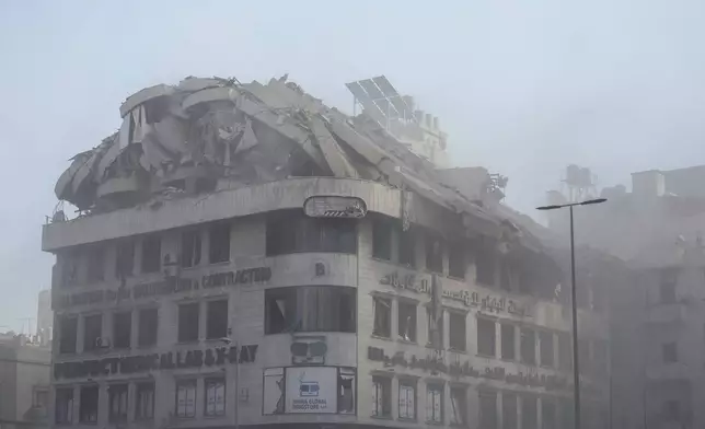 Smoke rises from a building that collapses following an Israeli airstrike on Chiyah, in the southern suburb of Beirut, Lebanon, Friday, Nov. 22, 2024. (AP Photo/Bilal Hussein)