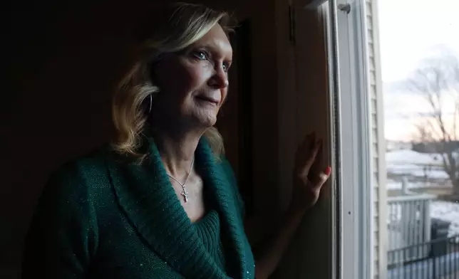 FILE - Christine Zuba, who came out as a transgender woman at age 58, stands for a portrait at her home in Blackwood, N.J., on Monday, Feb. 14, 2022. (AP Photo/Jessie Wardarski, File)