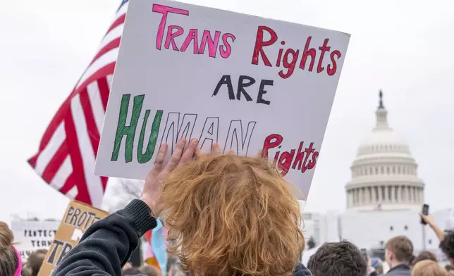 FILE - People attend a rally as part of a Transgender Day of Visibility, Friday, March 31, 2023, by the Capitol in Washington. (AP Photo/Jacquelyn Martin, File)